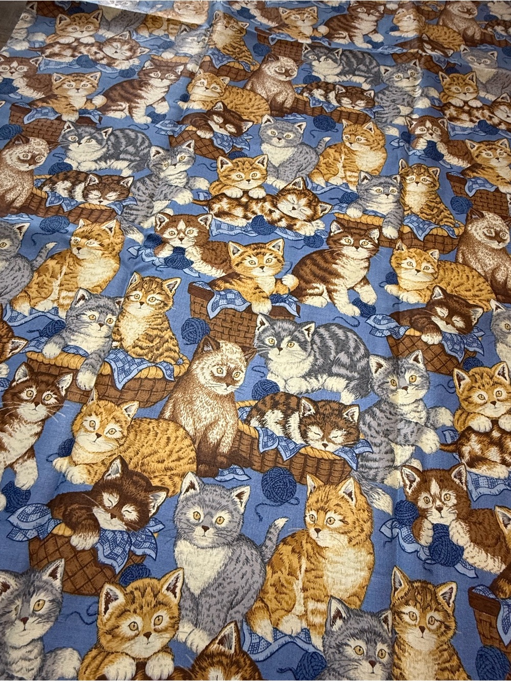 Cute blue playful cats pattern fabric material.